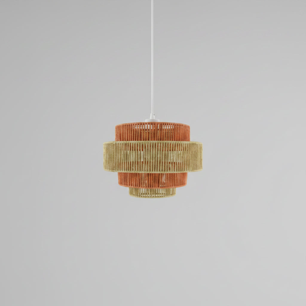 Chandelier with orange and gold design hanging in a room with a painting of trees on the wall.
