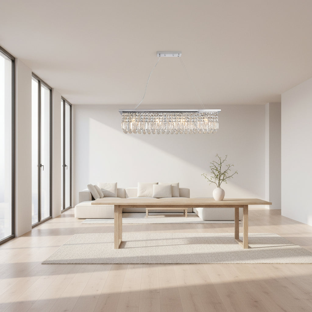 Modern dining room with a crystal chandelier, table, and chairs.