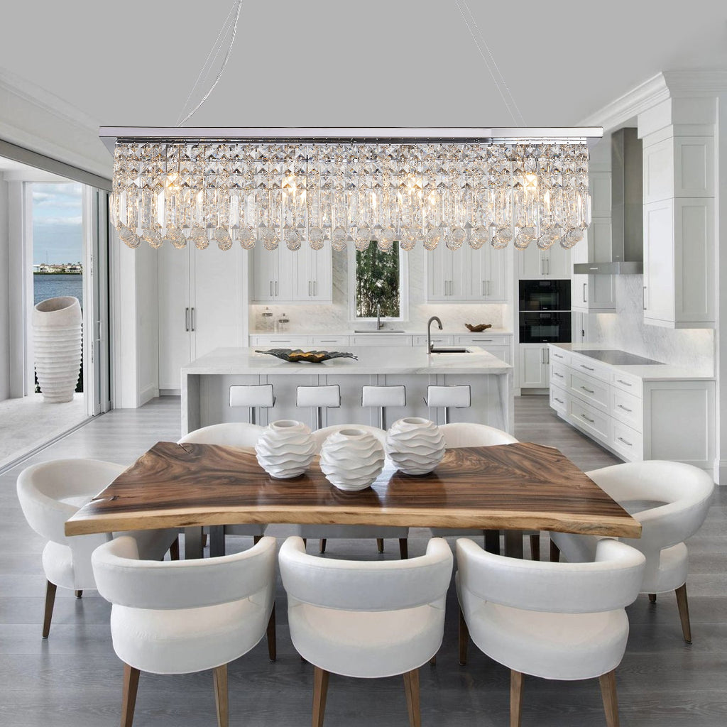 Modern dining room with a wooden table and white chairs, featuring a chandelier.