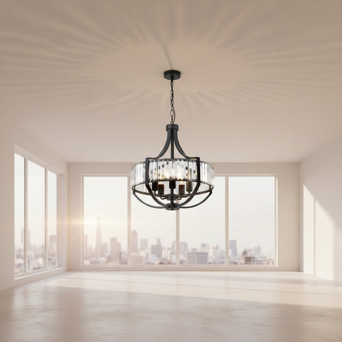 A round black metal chandelier with clear glass cylinder prisms and visible warm light bulbs, hanging in a bright white room with windows and framed wall art.