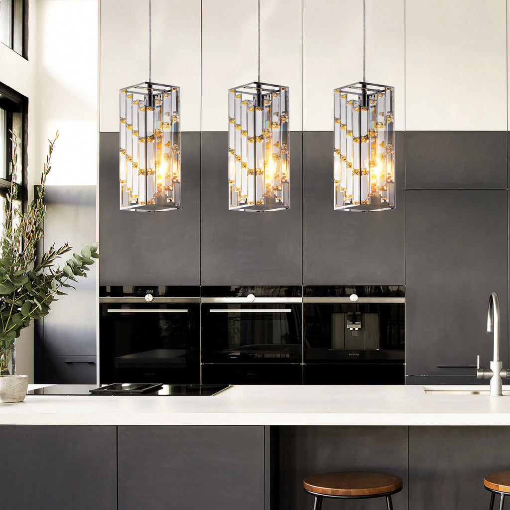 Modern kitchen with black glass panels, pendant lights, and a white countertop.