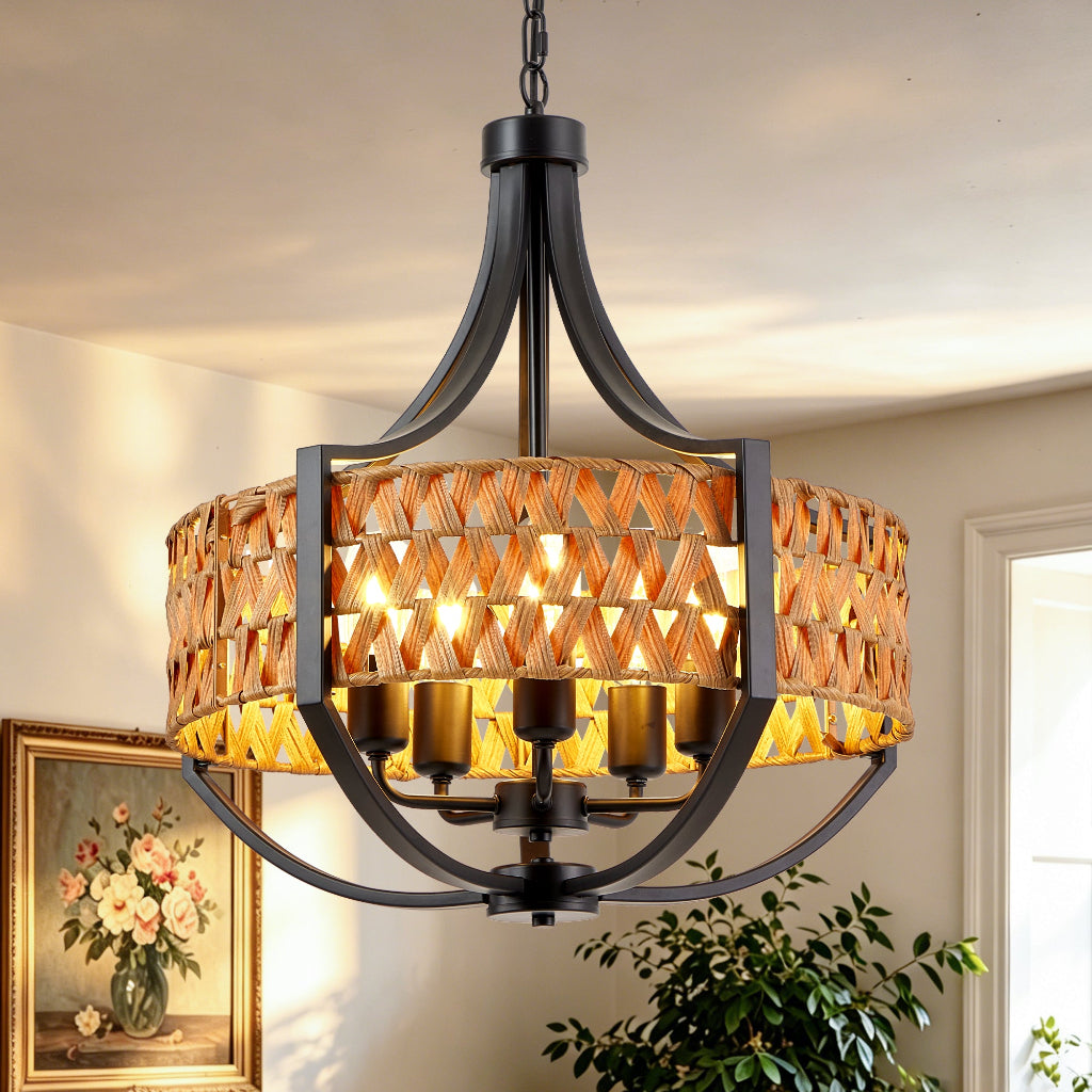 A multi-light chandelier with a black metal frame and a woven amber-gold shade, shown hanging in a home interior with warm lights turned on.