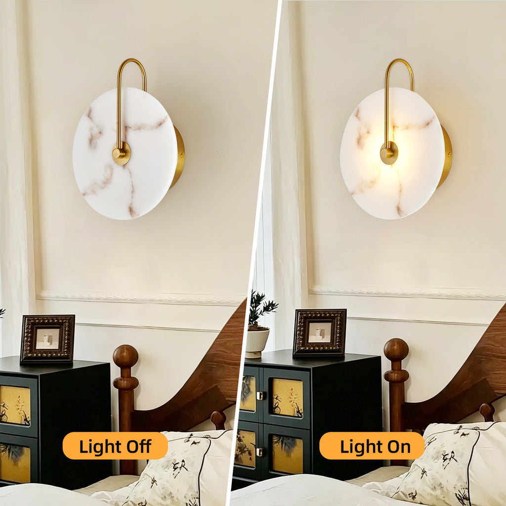 A split comparison showing a wall-mounted sconce in two states: left labeled 'Light Off' with the shade unlit, and right labeled 'Light On' with the shade illuminated. The fixture has a round white marble-look shade with a gold-toned curved arm and backplate, mounted above a bed in a bedroom setting.