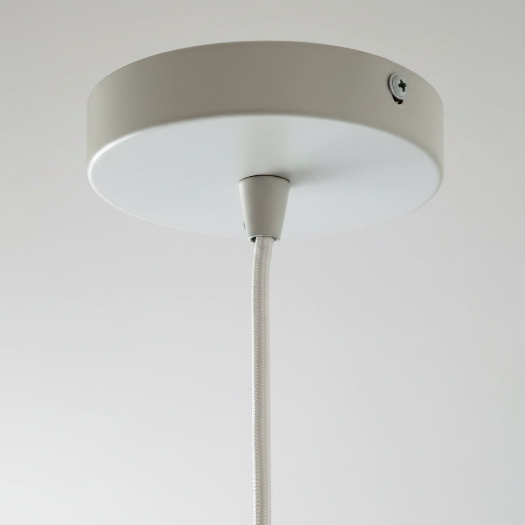 Ceiling light fixture with white shade on a white background